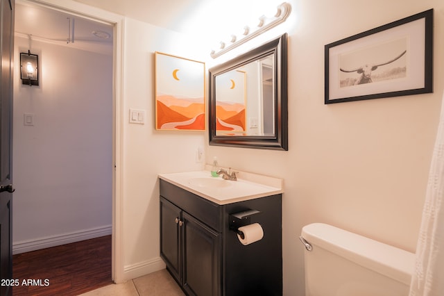 bathroom with tile patterned floors, vanity, and toilet