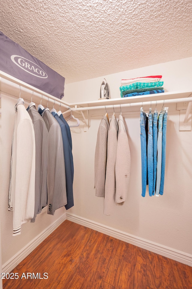 walk in closet with hardwood / wood-style floors