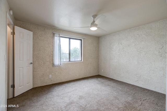 spare room featuring carpet flooring and ceiling fan