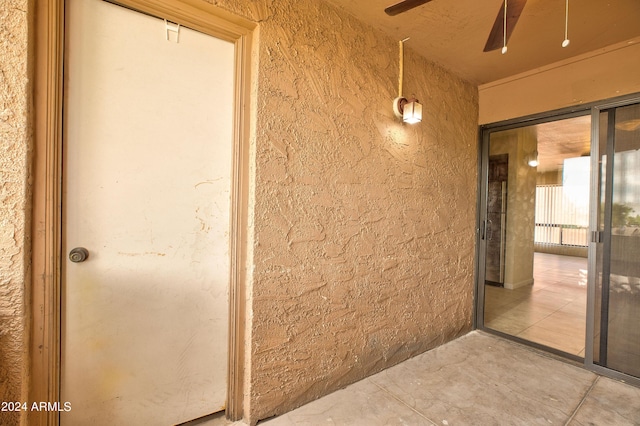 doorway to property featuring ceiling fan