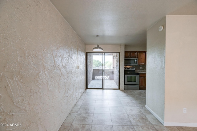 kitchen featuring light tile patterned floors, sink, appliances with stainless steel finishes, and tasteful backsplash