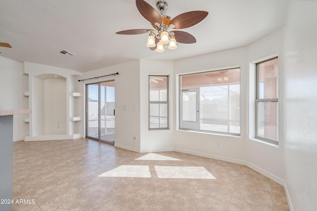 unfurnished room with ceiling fan