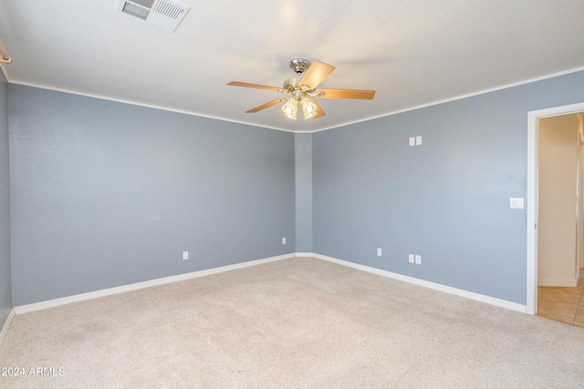 carpeted empty room featuring ornamental molding and ceiling fan