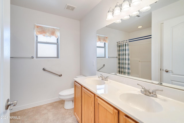 bathroom featuring vanity, a wealth of natural light, toilet, and walk in shower