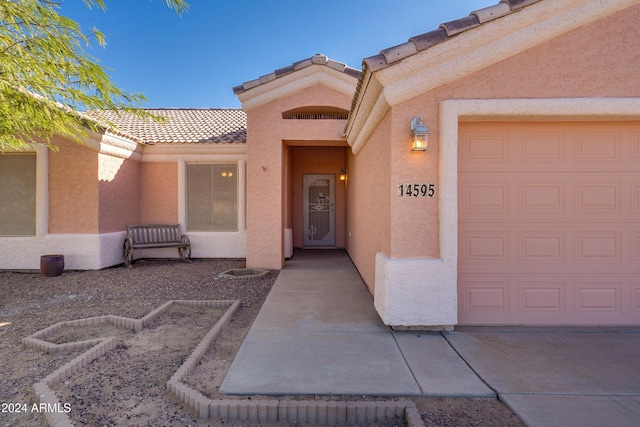 view of exterior entry with a garage