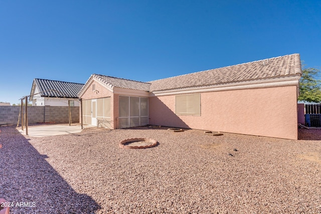 back of property featuring a sunroom and a patio