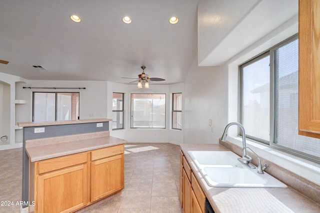 kitchen with light tile patterned flooring, sink, light brown cabinetry, and ceiling fan