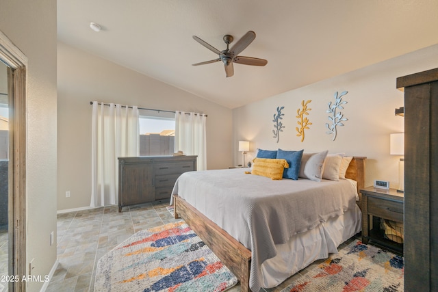 bedroom featuring vaulted ceiling, baseboards, and ceiling fan