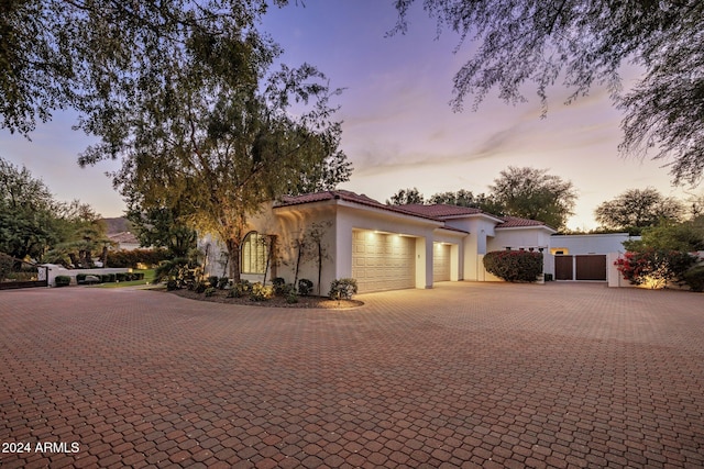 mediterranean / spanish home with a garage