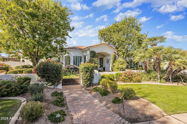 mediterranean / spanish house with a front yard