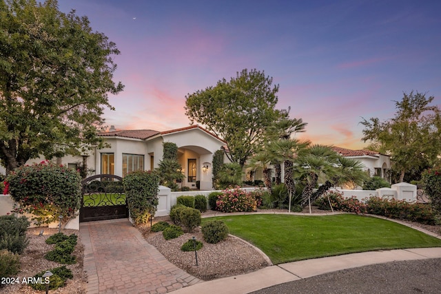 mediterranean / spanish-style home featuring a yard