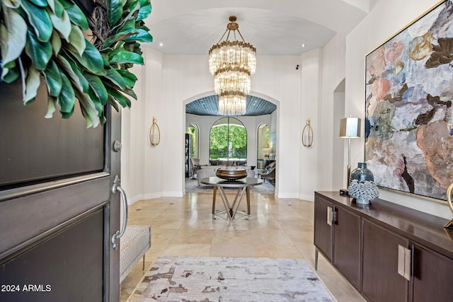 foyer entrance featuring light tile patterned floors and a high ceiling