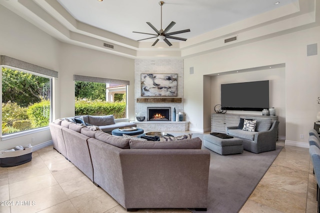 living room featuring a high ceiling, a tray ceiling, and ceiling fan