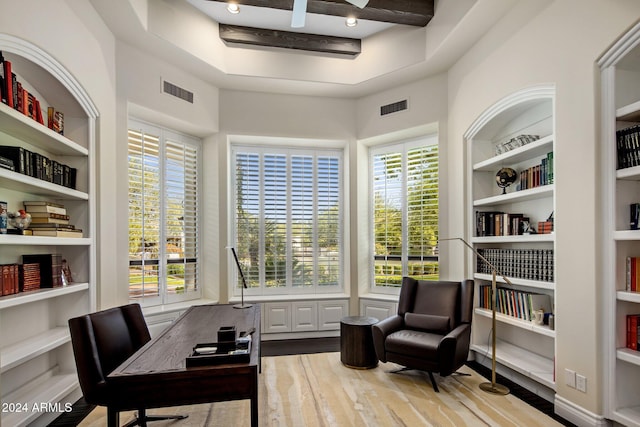 office space with built in features, wood-type flooring, and beam ceiling