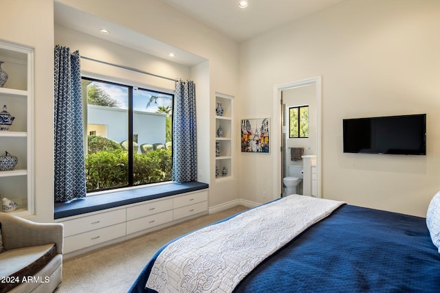 carpeted bedroom featuring ensuite bath