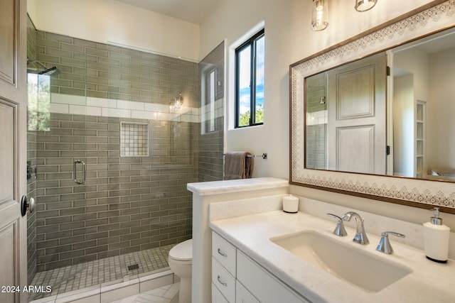 bathroom featuring tile patterned floors, vanity, toilet, and an enclosed shower