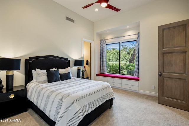 bedroom featuring light carpet and ceiling fan