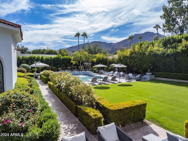 view of yard with a mountain view, pool water feature, and a patio area