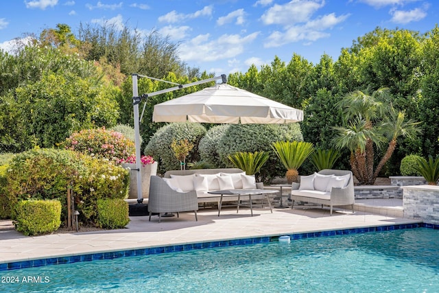 view of swimming pool featuring an outdoor living space and a patio area