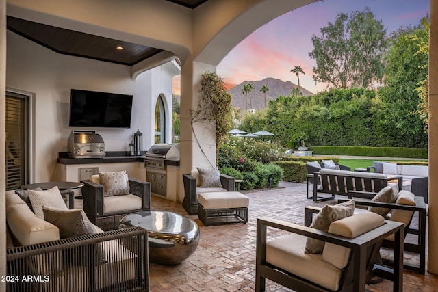 view of patio featuring outdoor lounge area, a grill, and exterior kitchen