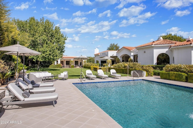 view of pool with a patio, outdoor lounge area, and a yard