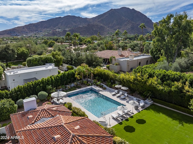 view of swimming pool with a mountain view and a patio area