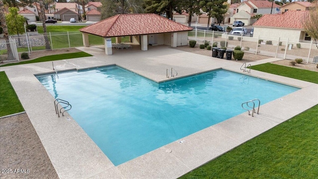 community pool featuring a gazebo, a residential view, a patio, and fence