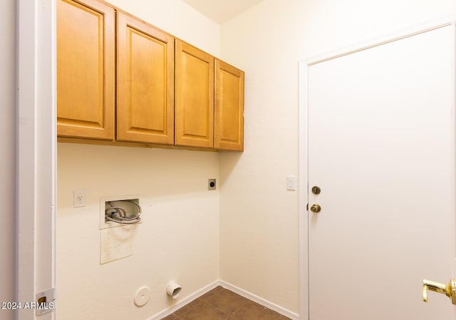 clothes washing area featuring hookup for a washing machine, cabinet space, gas dryer hookup, electric dryer hookup, and baseboards