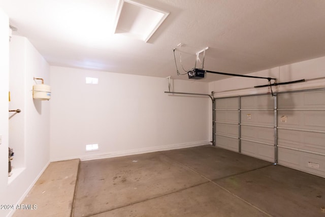 garage featuring baseboards and a garage door opener