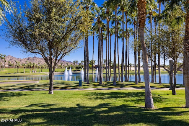 view of home's community featuring a lawn and a water and mountain view