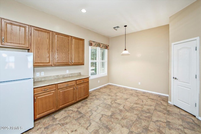 kitchen featuring hanging light fixtures and white refrigerator