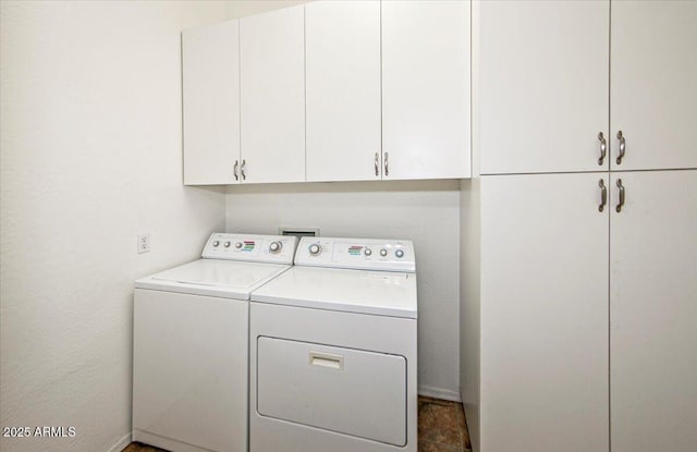 laundry area featuring cabinets and washer and clothes dryer