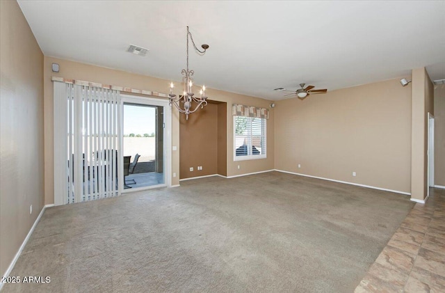 spare room featuring carpet floors and ceiling fan with notable chandelier