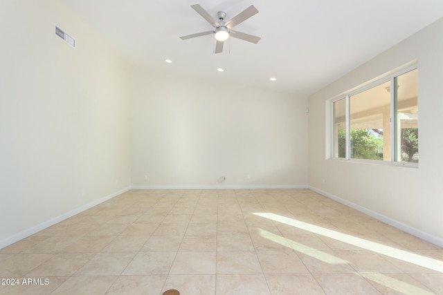 unfurnished room with ceiling fan and light tile patterned floors