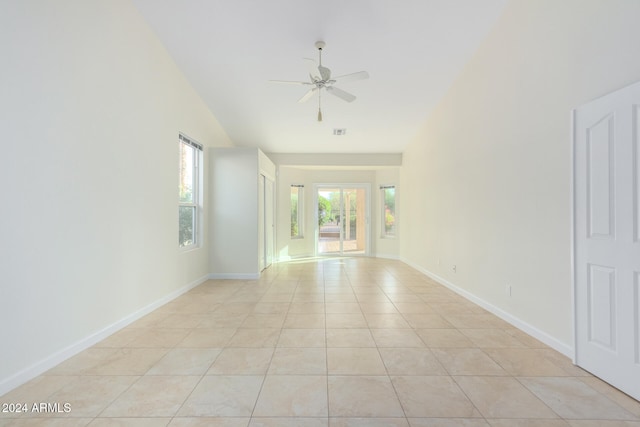 tiled spare room with ceiling fan and lofted ceiling