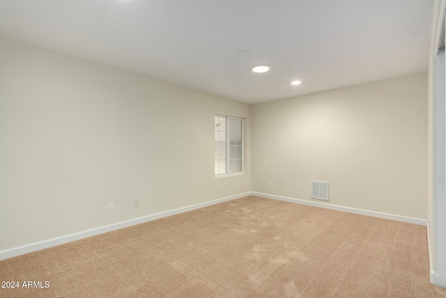 unfurnished room with light colored carpet