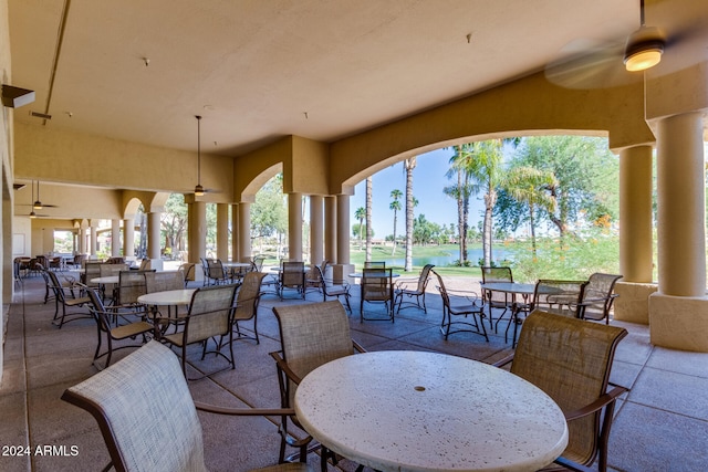 view of patio / terrace with ceiling fan and a water view