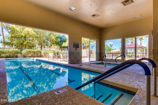 view of pool featuring an indoor hot tub