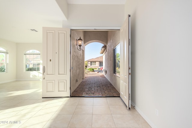 entryway featuring light tile patterned floors and a healthy amount of sunlight