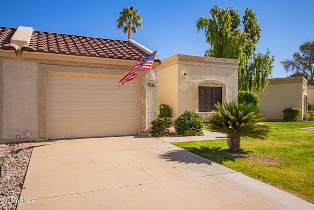 mediterranean / spanish-style home featuring a garage and a front yard