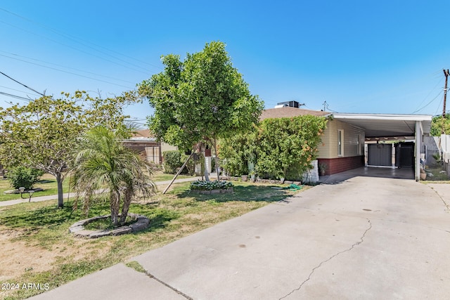 view of front of property with a front yard and a carport