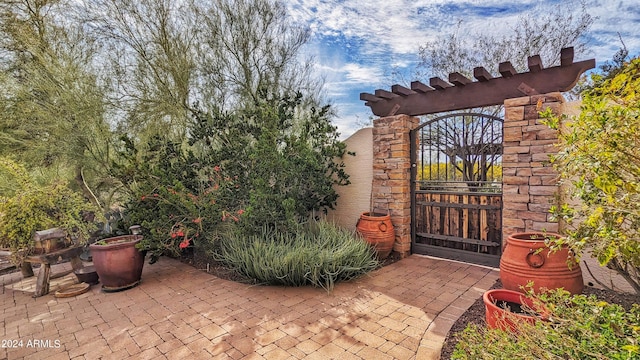 view of gate with a patio area