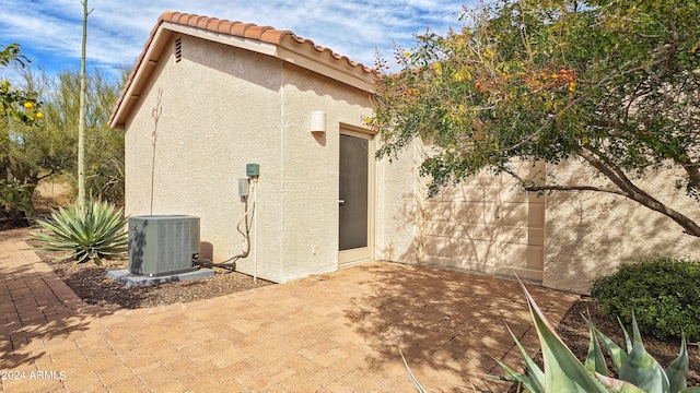 back of house featuring a patio area and central air condition unit