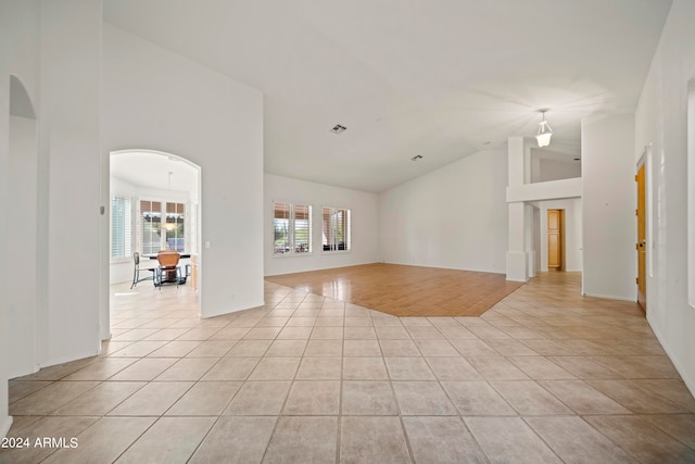 spare room with light hardwood / wood-style flooring and high vaulted ceiling