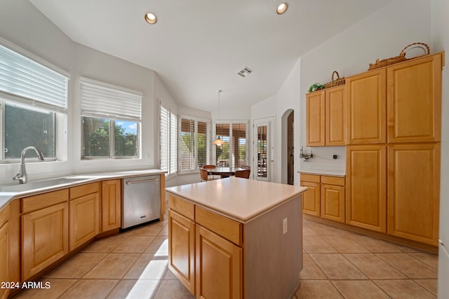 kitchen featuring lofted ceiling, hanging light fixtures, light tile patterned floors, a kitchen island, and dishwasher