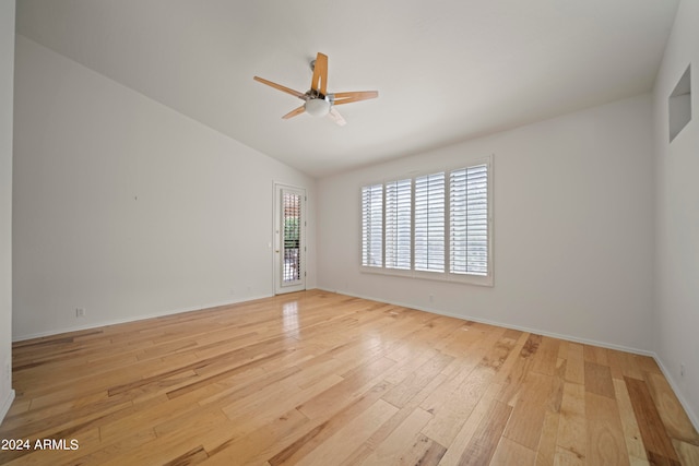 spare room with ceiling fan, light hardwood / wood-style flooring, and vaulted ceiling