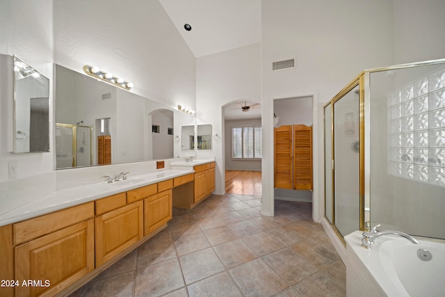 bathroom with high vaulted ceiling, vanity, independent shower and bath, tile patterned flooring, and ceiling fan