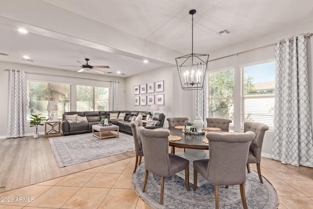 dining space featuring light tile patterned floors, visible vents, and plenty of natural light