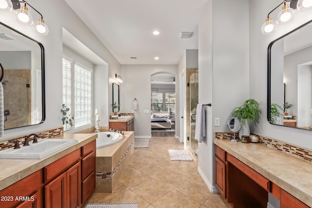 bathroom with a sink, visible vents, a healthy amount of sunlight, and a shower stall