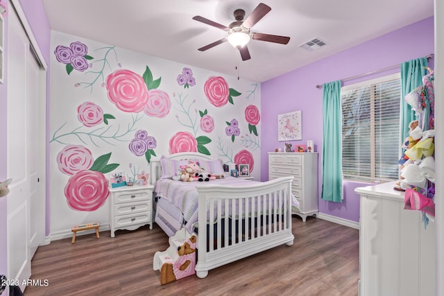 bedroom with visible vents, multiple windows, and wood finished floors